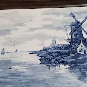 May include: A wooden tray with a blue and white ceramic tile inset depicting a Dutch landscape with a windmill, a house, and a sailboat on a canal.