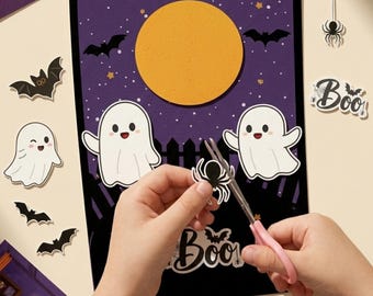 Puede incluir: Una hoja de manualidades rectangular con temática de Halloween que presenta un cielo nocturno morado, una luna amarilla grande, dos fantasmas blancos y una valla negra. Incluye elementos recortables como murciélagos, arañas y el texto Boo.