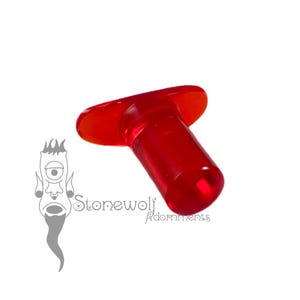 May include: A translucent red glass ear plug with a flat, flared front face and a cylindrical body. The object is positioned at an angle, showcasing its smooth, polished surface and vibrant crimson colour. The logo Stonewolf Adornments is visible.