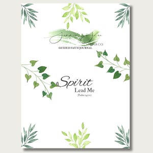 May include: A white journal cover featuring green watercolour leaf illustrations in the corners and centre. The text reads Jammie Shae Paper Co. Guided Faith Journal, Spirit Lead Me, and Psalm 143:10 in black script and serif fonts against a green brush stroke.