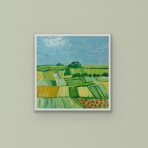 May include: A square oil painting in a white frame depicting a landscape with a blue sky, green fields, and patches of yellow and red crops. The brushwork is thick and textured, showing a rural scene with horizontal rows of vegetation and trees.
