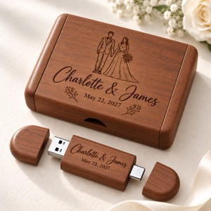 May include: A rectangular wooden box and a matching wooden USB flash drive. The box lid features an engraved illustration of a couple, the names Charlotte & James, and the date May 22, 2027. The USB drive also displays the same names and date.