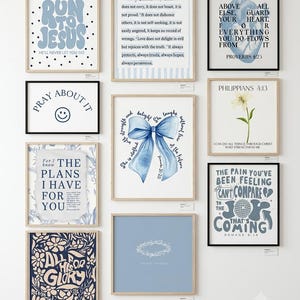May include: A collection of ten framed wall art prints featuring blue and white color schemes with various religious quotes, floral illustrations, a blue bow, a heart diagram, and a smiley face, all displayed in a grid arrangement on a wall.