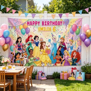 May include: A large rectangular birthday banner featuring a colorful illustration of various animated princesses, party balloons, and confetti. The text reads Happy Birthday Emilia 6. The banner is displayed outdoors against a white fence with colorful bunting.