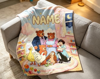 May include: A soft fleece blanket featuring a colorful illustration of a family of bears, a child, and various animals including a duck, chicken, owl, and cat. The word NAME is printed in large letters at the top above a night sky window scene.
