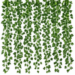 May include: A set of six hanging artificial ivy garlands featuring realistic green leaves with varied shades of light and dark green. Each vine consists of multiple stems with pointed, lobed foliage that cascades downward in a dense, uniform pattern.