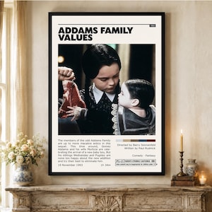 May include: A framed movie poster for Addams Family Values featuring a central image of Wednesday Addams holding a raw steak next to a baby. The poster includes the title, 1993 release date, a plot summary, production credits, and a PG-13 rating label.