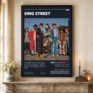 Könnte beinhalten: Ein gerahmtes Filmplakat für Sing Street, das eine Gruppe von sieben Personen in Kleidung der 1980er Jahre zeigt. Das Plakat enthält den Titel, das Jahr 2016, eine kurze Zusammenfassung, Regie- und Drehbuchangaben, Genres und ein PG-13-Label.