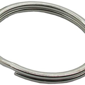 May include: A silver key ring with a double loop design. The ring is made of metal and has a smooth finish.