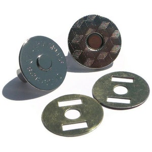 May include: Four silver magnetic snaps with a textured design. Two snaps have a metal post on the back. Two snaps have a metal loop on the back.