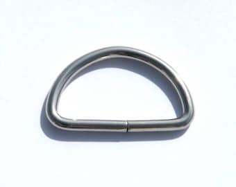 May include: A silver metal D-ring, also known as a D-shape ring, is a common hardware component used in various applications.