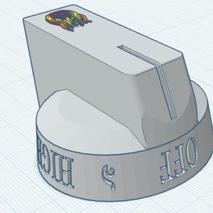 May include: A light grey control knob with a cylindrical base and a tapered top section featuring a vertical groove. The side of the base displays embossed text reading OFF and HIGH, while the top surface features a small, colourful graphic icon.
