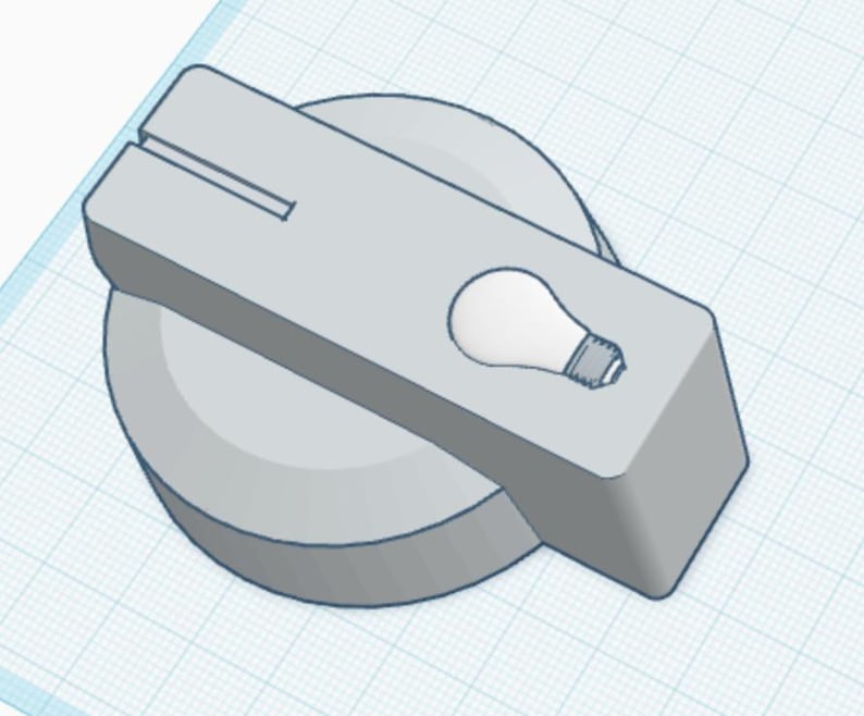 May include: A light grey control knob featuring a rectangular handle attached to a circular base. The handle displays a small, white graphic of a light bulb and a thin, straight horizontal slot near the top edge, rendered in a 3D digital design style.