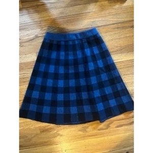 May include: A blue and black plaid skirt with a flared silhouette.