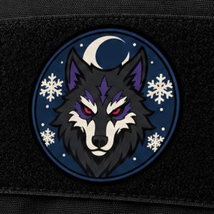 May include: A circular morale patch featuring a stylized wolf head with black fur, purple accents, and glowing red eyes. The background is a dark blue circle decorated with a white crescent moon and several white snowflake icons.