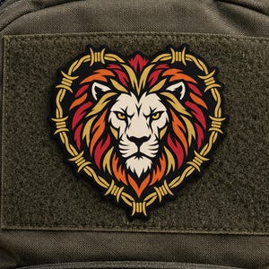 May include: A tactical morale patch featuring a stylized lion head with a vibrant mane of red, orange, and yellow flames. The lion is framed by a heart-shaped border made of yellow barbed wire, all set against a solid black background.