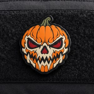 Toppa morale in PVC con teschio di zucca malvagio – Toppa tattica in gomma a forma di zucca di Halloween che si illumina al buio per zaini, giacche e cappelli