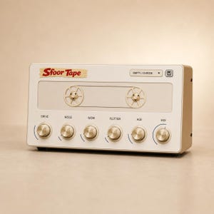 May include: A rectangular audio effects processor with a cream-colored faceplate featuring the text Sfoor Tape. It includes two gold-colored reel-to-reel spindles, a drop-down menu labeled EMPTY / CHOOSE, and six gold knobs labeled DRIVE, NOISE, WOW, FLUTTER, AGE, and MIX.