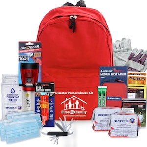 May include: A red backpack labeled Disaster Preparedness Kit with First My Family text, containing a Life Gear flashlight, 5-in-1 whistle, Datrex drinking water, blue face masks, a multi-tool, work gloves, a first aid kit, and emergency rations.