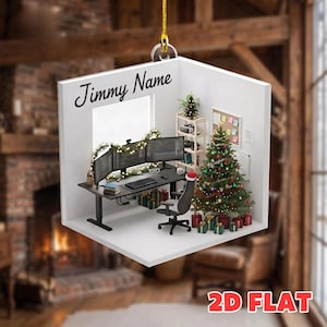May include: A flat, square-shaped hanging ornament featuring a 3D-style illustration of a home office setup with a desk, three computer monitors, a swivel chair with a Santa hat, a decorated Christmas tree, and gifts. The text Jimmy Name is printed.