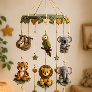 May include: A hanging nursery mobile featuring crocheted animal figures including a sloth, parrot, koala, tiger, lion, and elephant. The animals are suspended from a green circular frame decorated with crocheted leaves, hearts, and stars.