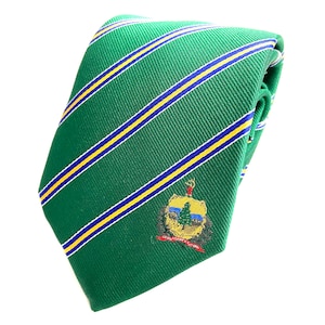 May include: A green striped tie with a yellow and blue stripe pattern. The tie features an embroidered crest with a tree, a deer, and the text "The Commonwealth of Pennsylvania".