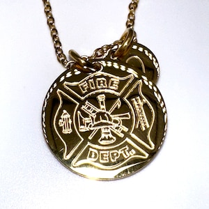 May include: Gold necklace with a round pendant featuring a fire department logo with a fire hydrant, axe, helmet, and ladder. The pendant says "FIRE DEPT."