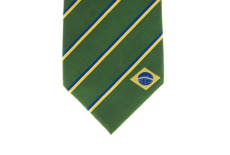 May include: A green tie with yellow and blue stripes and a small Brazilian flag embroidered on the bottom right corner.