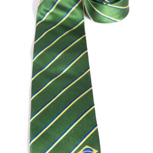 May include: A green and yellow striped tie with a small blue and yellow flag on the bottom right corner.
