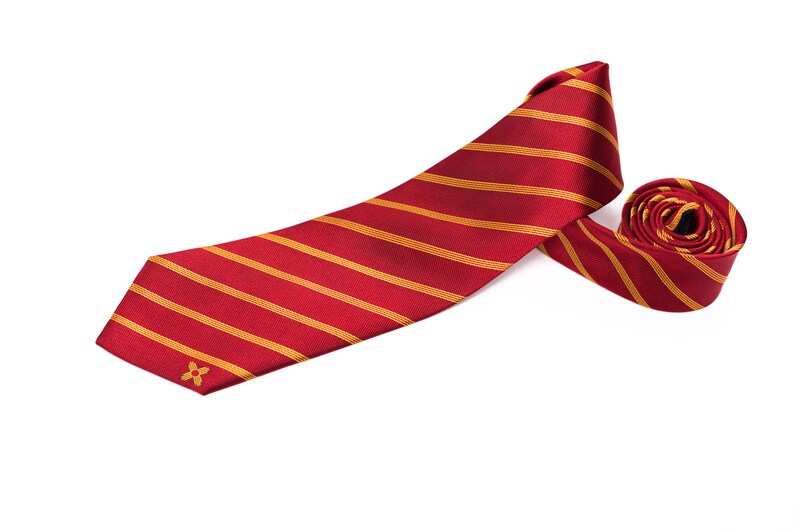 May include: A red and gold striped tie with a small gold flower design.