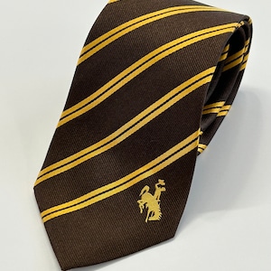 May include: A brown tie with diagonal yellow stripes and a small gold embroidered logo of a knight on horseback.