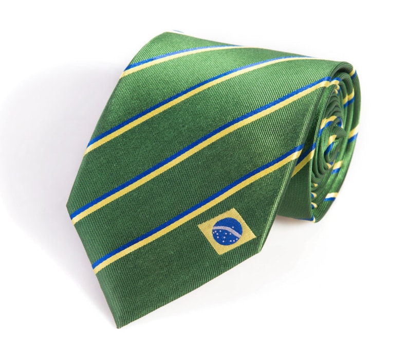 May include: A green and yellow striped tie with a small Brazilian flag embroidered on the front.