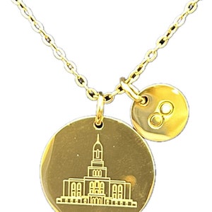 May include: Gold necklace with two charms. One charm features a detailed outline of a temple building. The other charm is a circle with the infinity symbol.