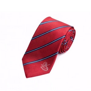 May include: A red striped tie with a white and blue stripe pattern. The tie has a small white logo on the front.