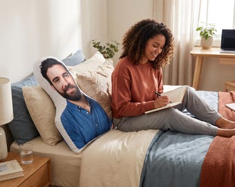 May include: A custom-shaped throw pillow featuring a high-resolution photographic print of a person with dark hair and a beard, wearing a blue button-down shirt. The pillow is white-backed and contoured to the head and torso of the subject.