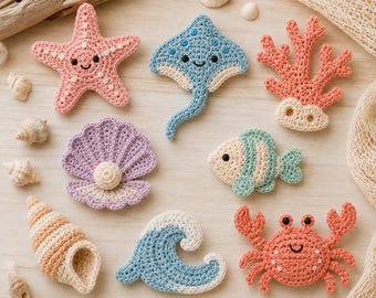 May include: A collection of eight crocheted sea-themed appliqués including a pink starfish, a blue stingray, a coral branch, a purple clam with a pearl, a striped fish, a tan spiral shell, a blue wave, and an orange crab with black eyes.