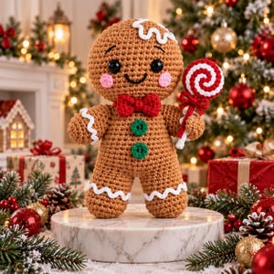 May include: A crocheted gingerbread person doll with a brown body, white icing details, black safety eyes, pink cheeks, a red bow tie, and two green buttons. The doll holds a red and white swirled lollipop in one hand.