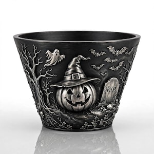 May include: A dark gray, metallic-finish planter featuring a raised, sculpted Halloween scene. The design includes a jack-o'-lantern wearing a witch hat, a ghost, flying bats, bare trees, a spider web, and a tombstone with the letters RIP.