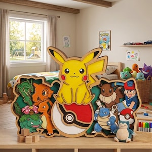 May include: A multi-layered wooden wall art piece featuring a yellow Pikachu sitting on a red and white Poké Ball, surrounded by various Pokémon characters including Bulbasaur, Charmander, Eevee, and Blastoise, alongside a human character.