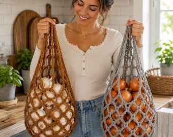 May include: Two reusable crochet produce bags with a diamond mesh pattern. One bag is a warm brown color filled with white garlic bulbs, and the other is a cool gray color filled with yellow onions. Both bags feature sturdy handles for carrying.
