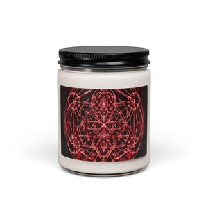 May include: A clear glass candle jar with a black metal lid containing white wax. The front label features a complex, symmetrical geometric pattern in shades of deep red and black, showcasing intricate intersecting lines and circular shapes.