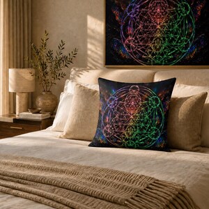 May include: A square throw cushion featuring a vibrant, multicoloured sacred geometry pattern against a dark background. The design displays intricate, glowing lines in shades of blue, green, purple, and red, forming a complex, symmetrical mandala-like structure.