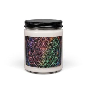 May include: A cylindrical glass candle jar with a black metal lid, containing white wax. The label features a vibrant, multicoloured geometric pattern with intersecting lines and circular shapes against a dark, nebula-like background.