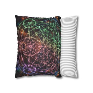 May include: A rectangular throw pillow featuring a dark background with a vibrant, glowing fractal pattern in shades of green, pink, and blue. The reverse side of the pillow displays a pattern of thin, horizontal white and grey stripes.