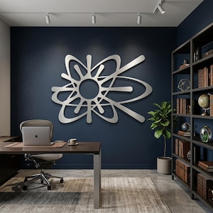 May include: A large, silver-colored metal wall art piece featuring an abstract, multi-layered atomic or starburst design with curved, intersecting lines and a central circular cutout, mounted on a dark navy blue wall in a home office setting.