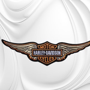 May include: An embroidered patch featuring the Harley-Davidson Motor Cycles logo with a central rectangular emblem and stylized wings extending to the sides. The design uses black, orange, and silver thread on a dark background with clear text.