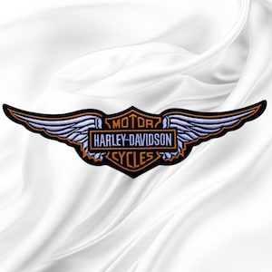 May include: An embroidered patch featuring the Harley-Davidson Motor Cycles logo with stylized wings. The design includes light blue wing details, orange outlines, and black lettering on a dark background, forming a wide, horizontal emblem.