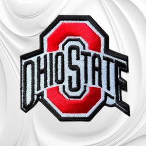 May include: An embroidered patch featuring the Ohio State logo with a red block O shape centered behind the black text OHIO STATE, outlined in white and black thread, creating a bold graphic emblem suitable for attachment to fabric items.