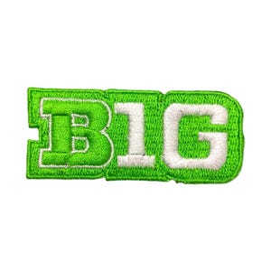 May include: An embroidered patch featuring the word BIG in a bold, block-style font. The letters are white with a thick, bright lime green border and a textured green background fill, creating a distinct rectangular shape with rounded edges.