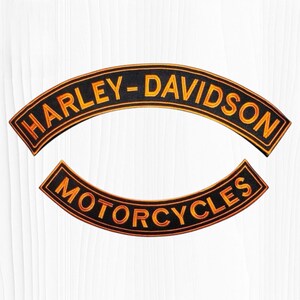 May include: Two curved embroidered patches with black backgrounds and orange borders. The top patch features the text HARLEY-DAVIDSON in orange, and the bottom patch features the text MOTORCYCLES in orange, both in a bold, sans-serif font.